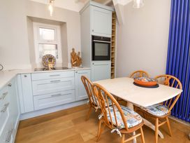 A kitchen with a dining table and chairs at Seacroft in Combe Martin