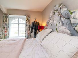 A bedroom with a bed and a window at Seacroft in Combe Martin