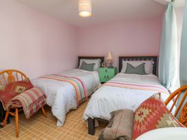 A bedroom with two beds and a nightstand at Seacroft in Combe Martin