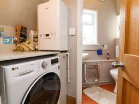 A laundry room with a washing machine and boiler at Seacroft in Combe Martin
