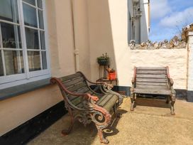 An outdoor area with benches and a flower pot at Seacroft Combe Martin