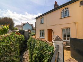 A house with a pathway and stream in front at Seacroft in Combe Martin