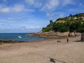 A beach with boats and people at Seacroft in Combe Martin