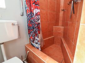 A bathroom with a shower and toilet at Seacroft Cottage Combe Martin