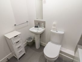 A bathroom with a toilet and sink at Harbourside Apartments in Whitehaven