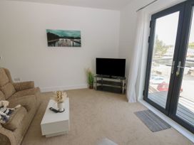 A living room with a sofa and television at Seaview in Whitehaven