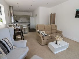 A living room with a sofa and dining table at Seaview in Whitehaven
