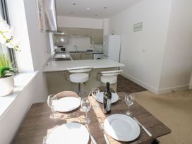 A kitchen and dining area with a table set at Seaview in Whitehaven