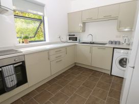 A kitchen with appliances and a window at Seaview in Whitehaven