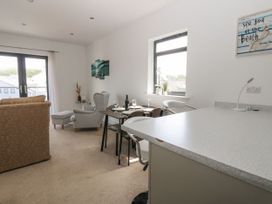A living room with a sofa and dining area at Seaview in Whitehaven