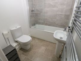 A bathroom with a bathtub, shower, toilet, and sink at Seaview in Whitehaven