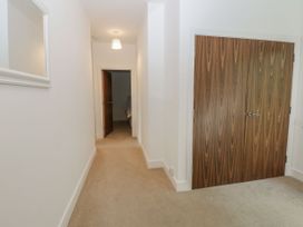A hallway with mirror and doors at Seaview in Whitehaven