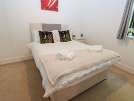A bedroom with a bed and nightstand at Seaview in Whitehaven
