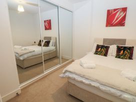 A bedroom with a bed and a mirror at Seaview in Whitehaven