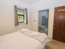 A bedroom with a bed and towels at Seaview in Whitehaven