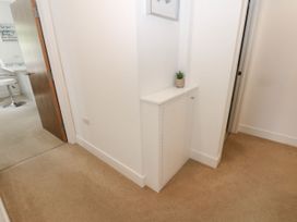 A hallway with a cabinet and a plant at Seaview in Whitehaven