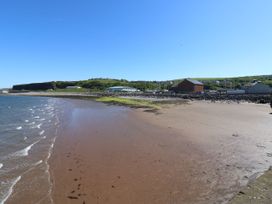 A beach with water and cliffs at Seaview in Whitehaven