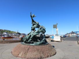 A sculpture of fish at a marina in Whitehaven