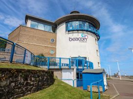 A museum building with a fence and pathway at Seaview in Whitehaven