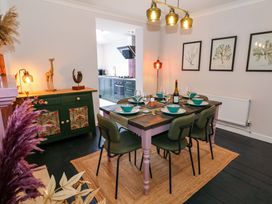 A dining room with a table set for dinner at Otter Cottage in Weymouth