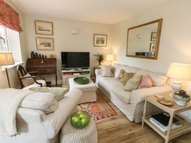 A living room with a sofa and television at 31 Bull Lane Dorchester