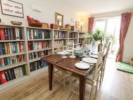 A dining room with a table set for meals at 31 Bull Lane, Dorchester