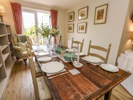 A dining room with a wooden table set for a meal at 31 Bull Lane in Dorchester