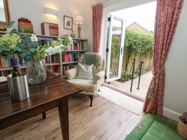 A snug with a bookshelf and a chair at 31 Bull Lane in Dorchester