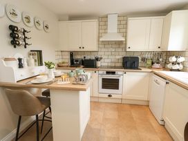 A kitchen with cabinets, appliances, and a dining table at 31 Bull Lane in Dorchester