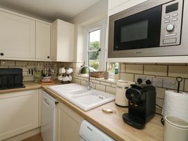 A kitchen with a sink, microwave, and coffee machine at 31 Bull Lane Dorchester