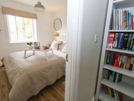 A bedroom with a bed and bookshelf at 31 Bull Lane in Dorchester