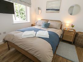 A bedroom with a bed and nightstand at 31 Bull Lane in Dorchester