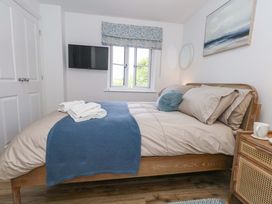 A bedroom with a bed and television at 31 Bull Lane Dorchester