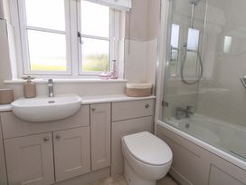 A bathroom with a sink, toilet, and shower at 31 Bull Lane Dorchester