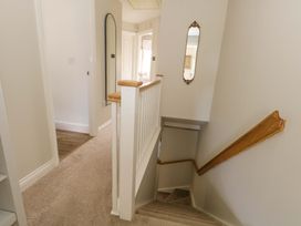 A hallway with a staircase and a mirror at 31 Bull Lane Dorchester