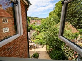 A view of a garden with trees and furniture from a window at 31 Bull Lane in Dorchester