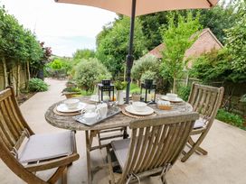 A garden with a table and chairs set for tea at 31 Bull Lane in Dorchester
