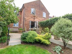 A garden with a table and chairs under an umbrella at 31 Bull Lane Dorchester