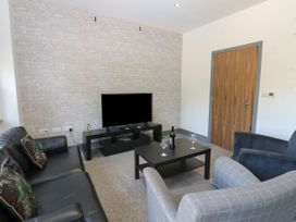 A living room with a television and seating at Quayside Apartments in Whitehaven