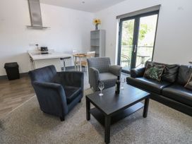 A living room with a black sofa and coffee table at Quayside Apartments in Whitehaven
