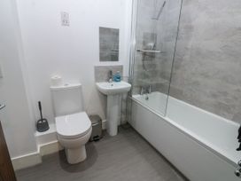 A bathroom with a toilet, sink, and bathtub at Quayside Apartments in Whitehaven