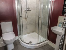 A bathroom with a shower cubicle, toilet and sink at Quayside Apartments in Whitehaven