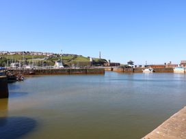 Boats at a harbor with hills in the background at Quayside Apartments in Whitehaven