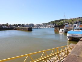 A harbor with boats and a pier at Quayside Apartments in Whitehaven