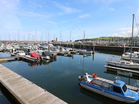 A marina with various boats docked at Quayside Apartments Whitehaven