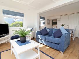 A living room with a sofa and TV at Stella Maris in Torpoint