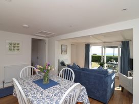 A living room with a dining area and sofa at Stella Maris in Torpoint