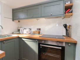 A kitchen with cabinets and appliances at Stella Maris in Torpoint