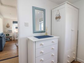 A hallway with a chest of drawers and mirror at Stella Maris in Torpoint