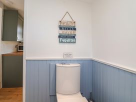 A bathroom with a toilet and sign at Stella Maris in Torpoint